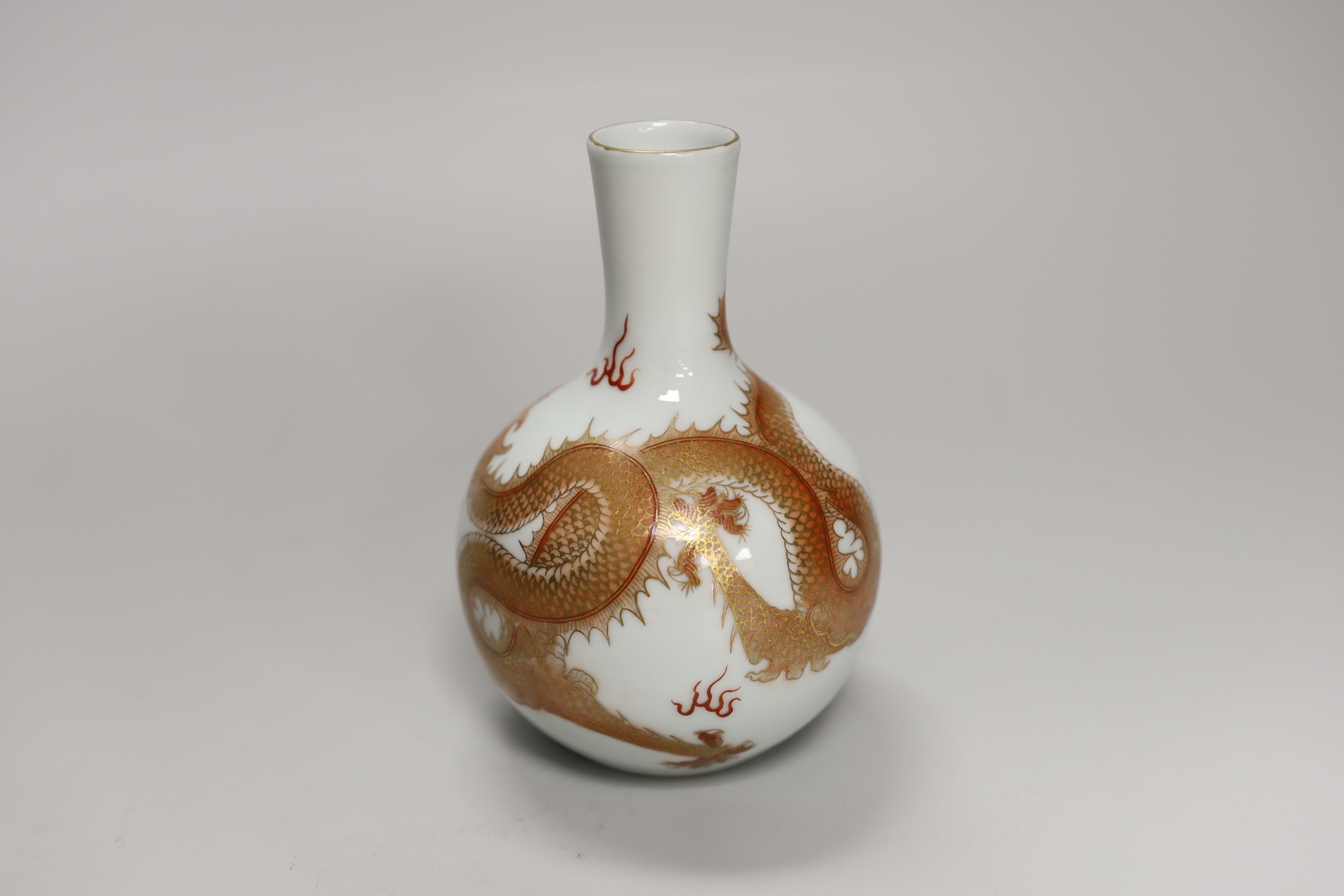 A Chinese rouge de fer decorated ‘dragon’ bottle vase, 14cm high (boxed)